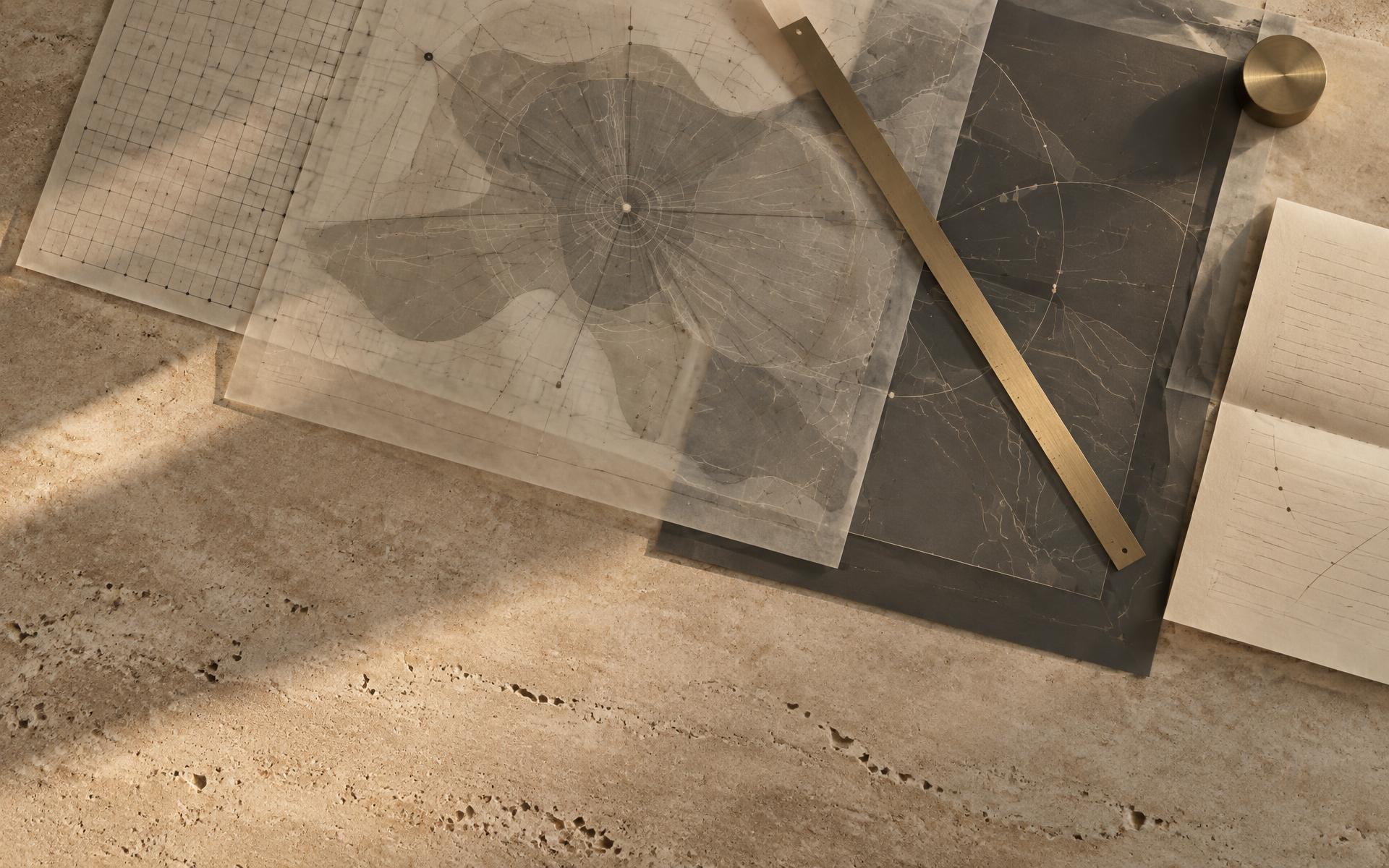 Translucent and graphite sheets laid over one another on warm stone — a grid, a zoned region and radiating connection lines aligning so the layers read as one business system seen in section, crossed by a single brass datum rule